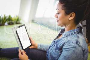 Businesswoman using digital tablet in creative office