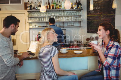 Happy customers at counter in cafeteria