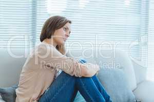 Sad woman sitting on sofa