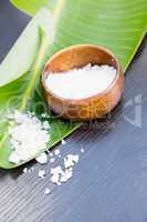 Salt in bowl with banana leaf on table