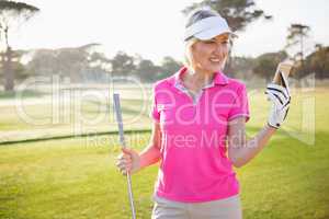 Woman golfer looking her mobile phone