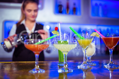 Bartender working with cocktail glasses on counter