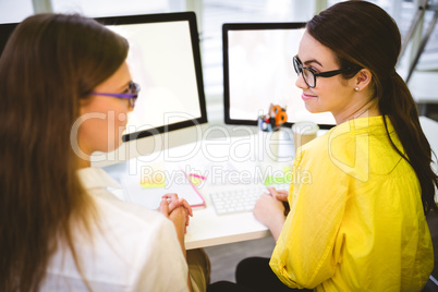 Rear view of coworkers sitting at creative office