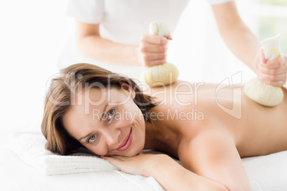 Portrait of woman receiving herbal compress massage