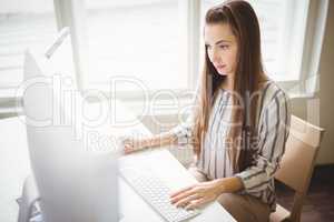 Young businesswoman working on computer in office