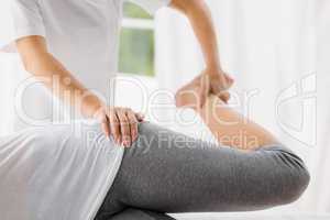 Masseur stretching woman