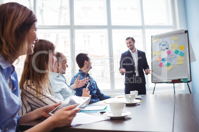 Businessman giving presentation in front of coworkers