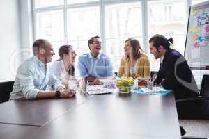 Colleagues discussing in meeting room