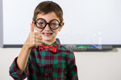 Portrait of smiling boy gesturing thumbs up sign