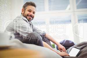 Young businessman working digital tablet in creative office