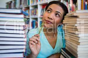 Thoughtful young woman in library