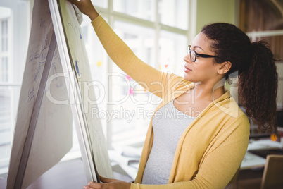 Businesswoman preparing board for presentation in creative offic