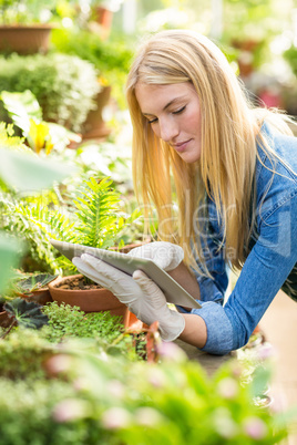 Gardener using digital tablet while working