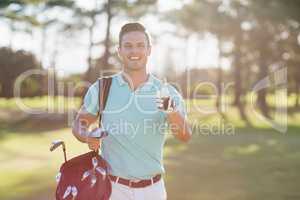 Portrait of smiling golfer man showing thumbs up