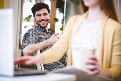 Smiling businessman with female coworker