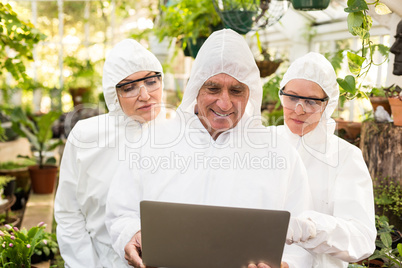 Male scientist discussing with colleagues over laptop