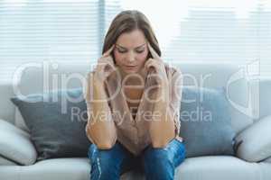 Sad woman sitting on sofa