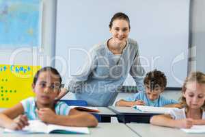 Smiling female teacher with children