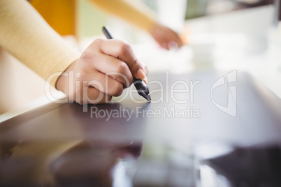 Cropped image of businesswoman writing on paper