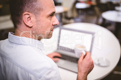 Rear view of businessman drinking coffee at creative office