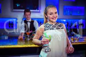 Portrait of smiling woman standing against bartender