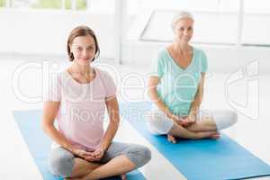 Portrait of smiling women doing yoga