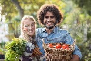 Portrait of couple carrying fresh vegetables