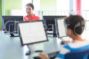 Teacher using computer in classroom