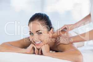Relaxed happy woman receiving massage