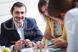 Portrait of smiling male photo editor with colleagues