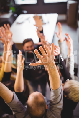 Business people cheering in creative office