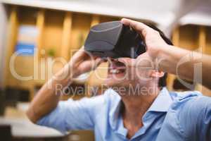 Close-up of businessman enjoying augmented reality headset at of