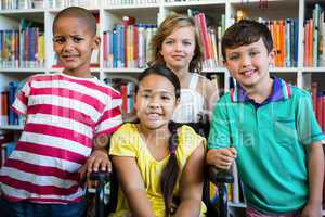 Handicapped girl with friends at library in school