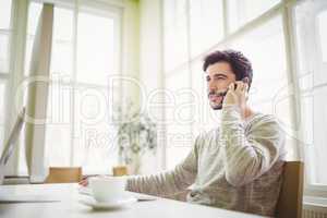 Businessman using mobile phone in office