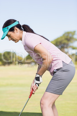 Sportive woman playing golf