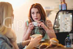 Attractive woman talking to friend at cafe