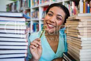 Portrait of thoughtful young woman in library