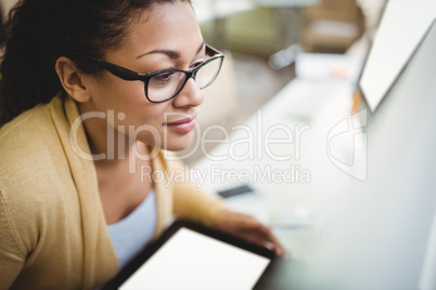 Businesswoman using digital tablet at creative office