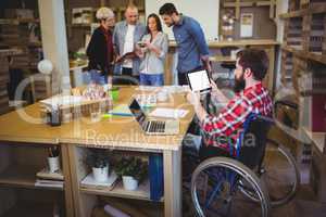 Disabled businessman using digital tablet at desk