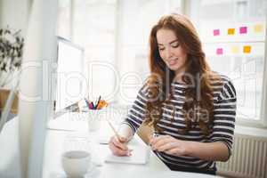 Young businesswoman working in creative office