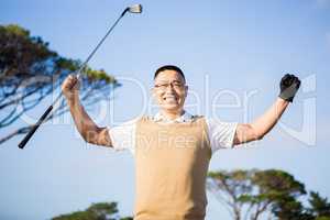 Golfer raising his hands