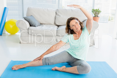 Mature woman stretching on exercise mat