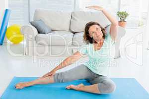 Mature woman stretching on exercise mat