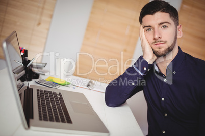 Portrait of sad businessman at office