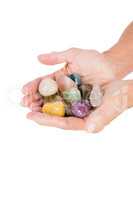 Cropped image of person holding colorful pebbles