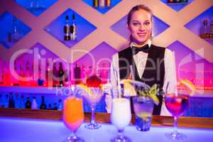 Portrait of smiling barmaid standing