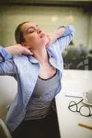 Businesswoman stretching in office