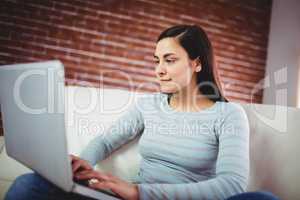 Young woman using laptop at home