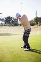 Side view of sportsman playing golf