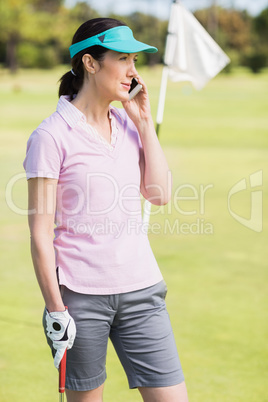 Golfer woman talking on phone